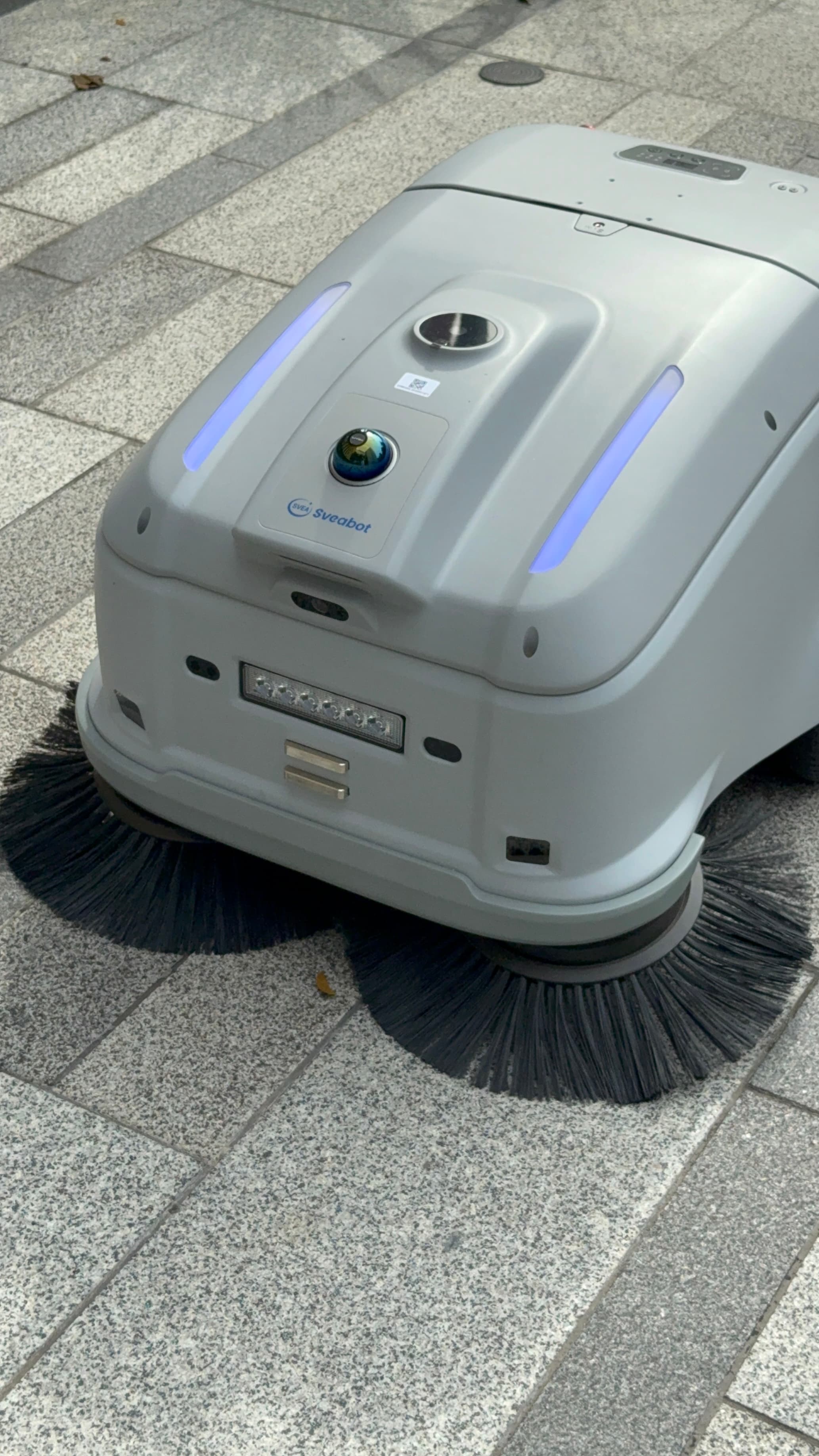 Close-up of the Sveabot V100's front sensor pod with camera and LiDAR